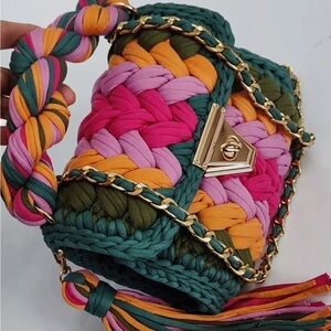 Handmade recycled cotton handbag. Has a long strap handle and a short handle.